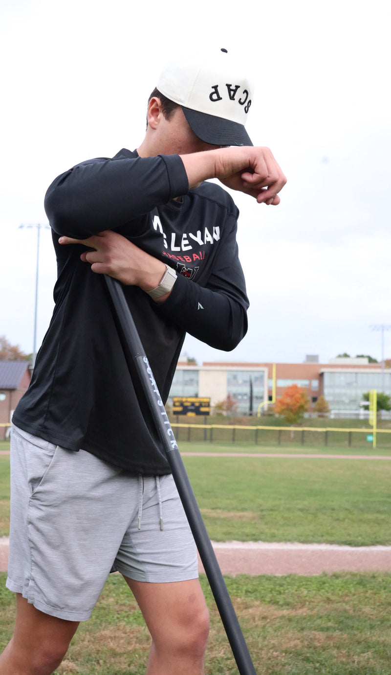 Athlete using ScapStick V2 for shoulder blade muscle recovery - deep tissue therapy tool for baseball players